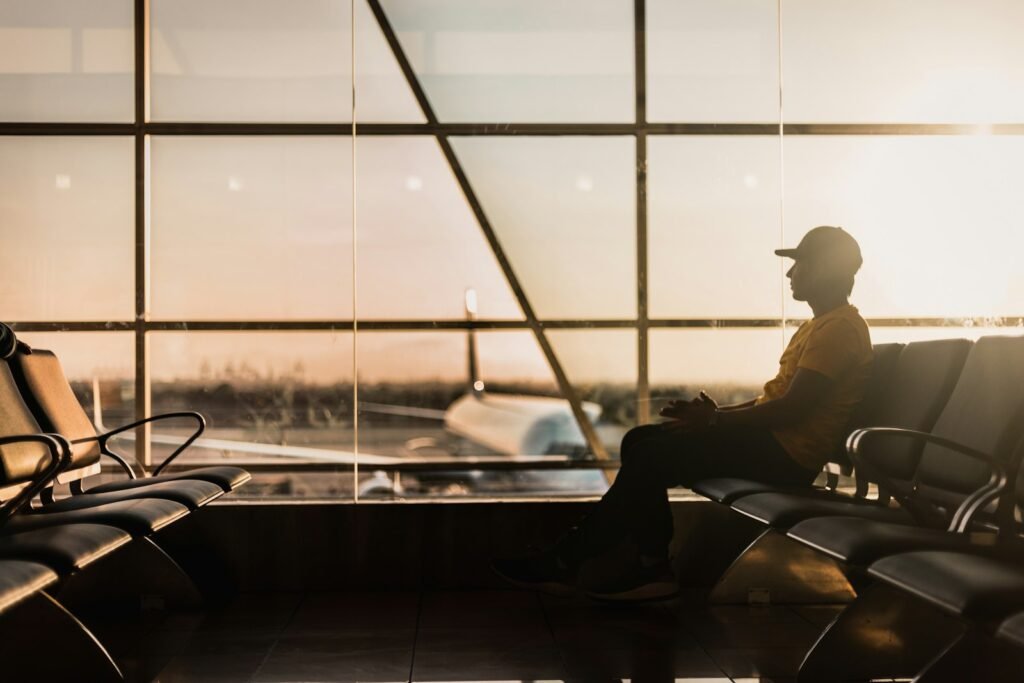 Traveller waiting near an airport window